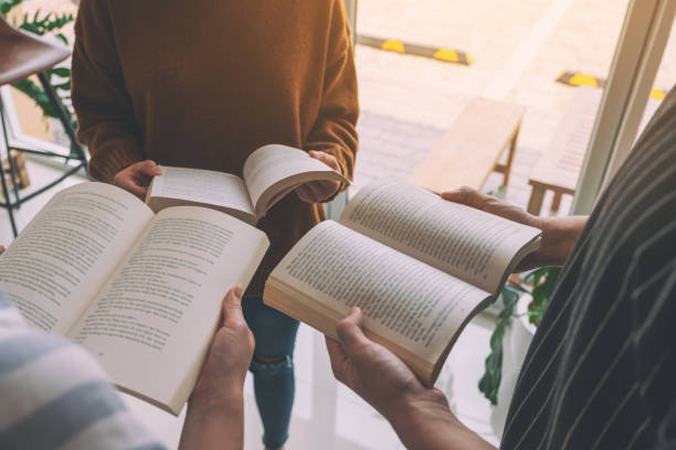 istock people standing in circle and enjoyed reading books together 1153796190