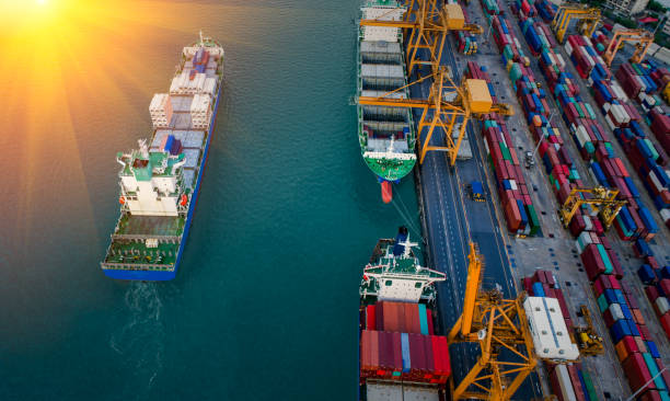 istock Logistics and transportation of Container Cargo ship and Cargo plane with working crane bridge in shipyard at sunset, logistic import export and transport industry background 1153798471