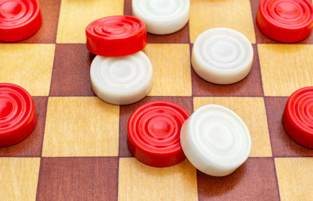 istock Checkers on wooden checkerboard. Close up. 1153798609