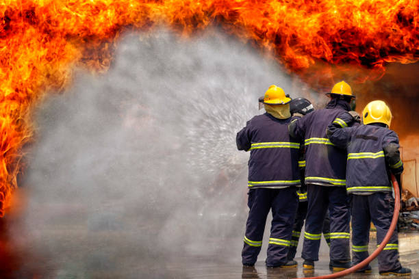 istock Fireman,fireman using water and extinguisher to fighting with fire flame in an emergency situation., under danger situation all firemen wearing fire fighter suit for safety. 1153800074
