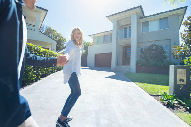 istock Couple joyfully running into their new home. 1153800189