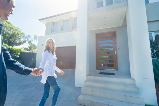 istock Couple joyfully walking into their new home. 1153800212