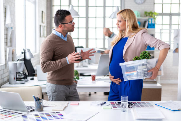 Pregnant woman in office, ready for maternity leave stock photo