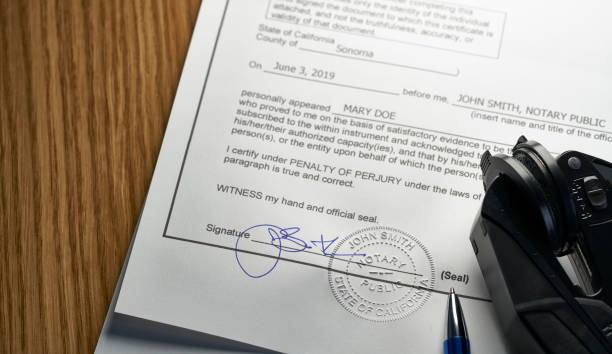 istock Notary Public: Seal embossed on document with pen and glasses 1153803607