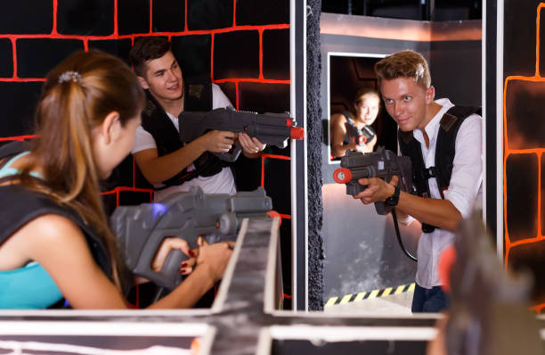 istock young people  enthusiastically playing laser tag 1153803664