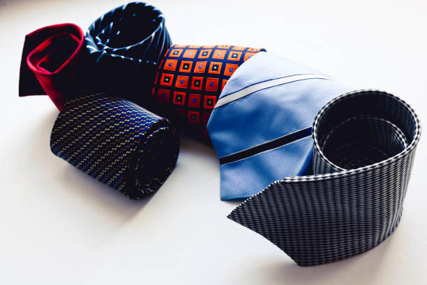 Bunch of colorful neckties grouped on table.