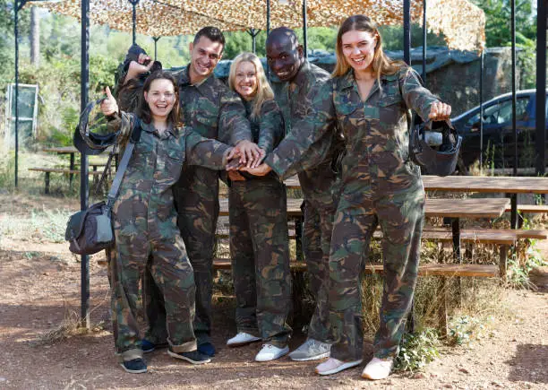 Photo of Smiling team of players wearing camouflage