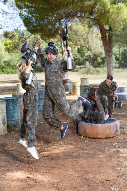 istock Satisfied paintball players won match 1153804018