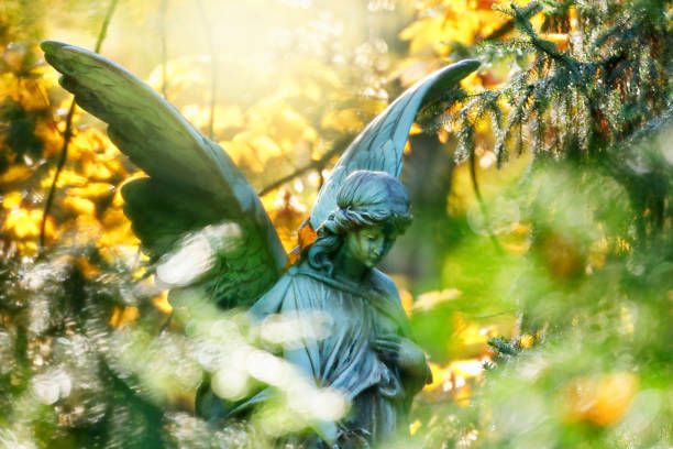 istock Antique Angel Statue on a Graveyard 1153805450