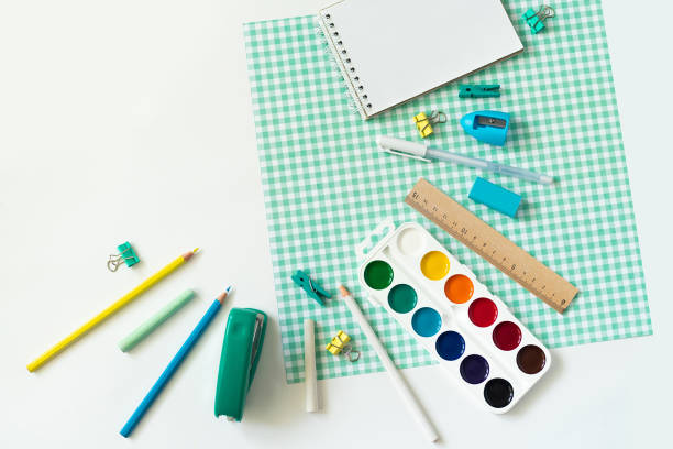 istock School supplies on white and blue checkered background 1153805694