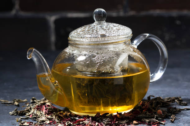 istock fresh tea in a glass teapot on dark background, closeup 1153810089