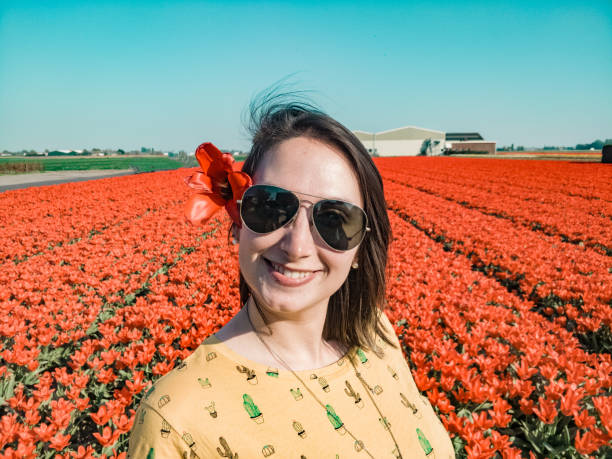 istock Woman with flower, fields in the Netherlands 1153810165