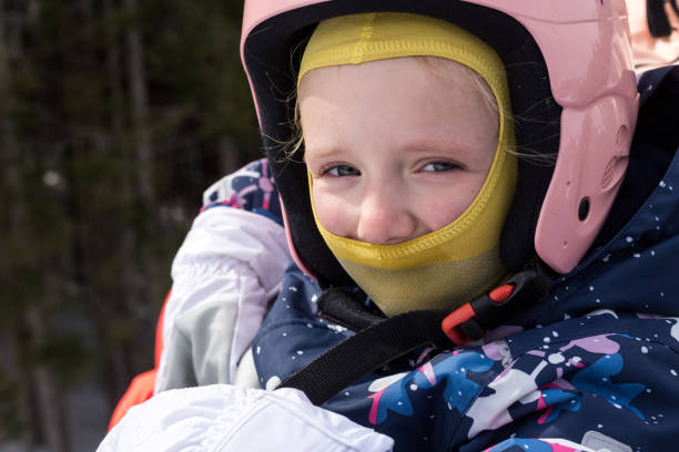 istock Child in a ski suit on a ski lift. 1153810992