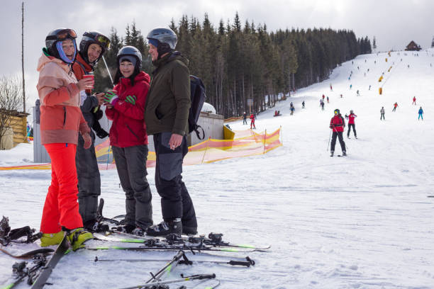 istock Friends relax and drink tea after skiing. 1153812556