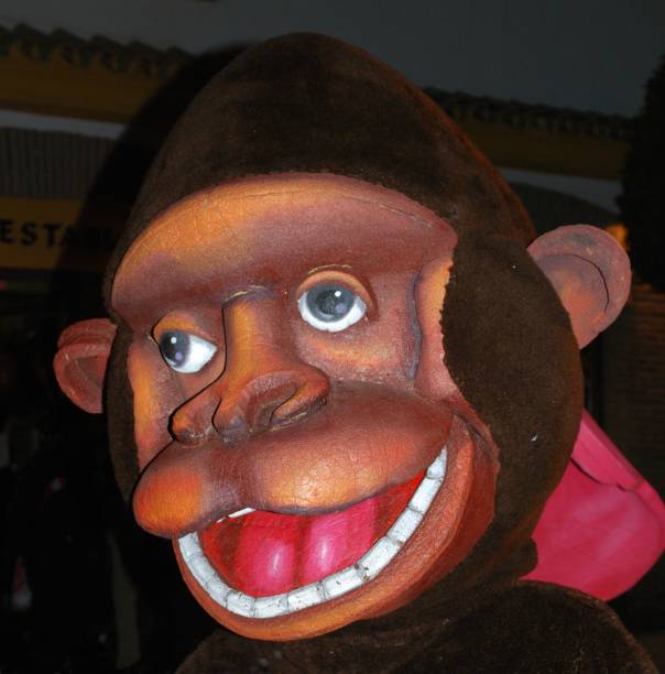 Person in a monkey fancy dress suit walking through the street during the Three Kings Parade, La Cala de Mijas, Costa del Sol, Malaga Province, Andalucia, Spain, Europe, January 5, 2009.