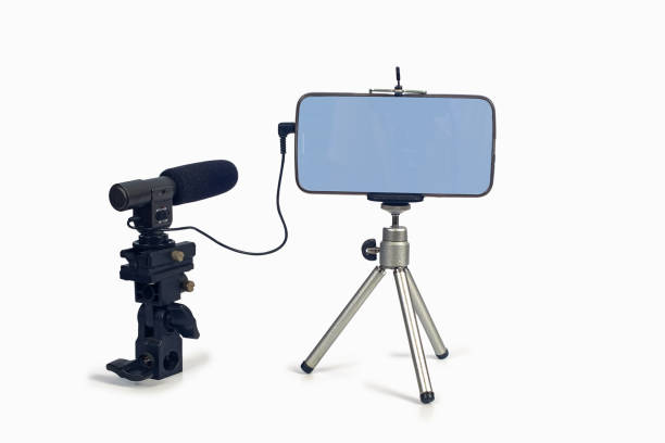 istock streaming video live with smart phone and microphone tool. 1153814710
