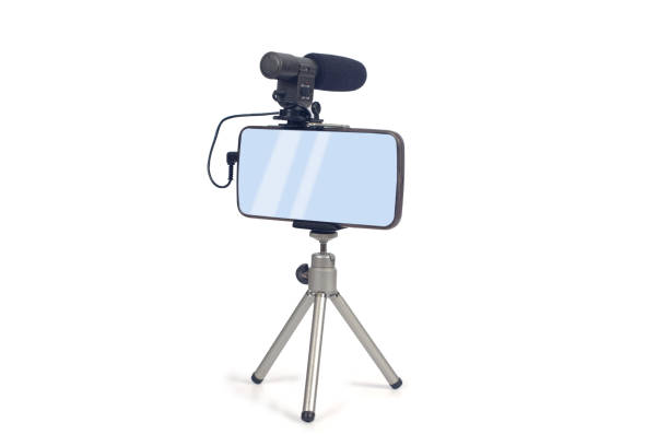 istock streaming video live with smart phone and microphone tool. 1153814716