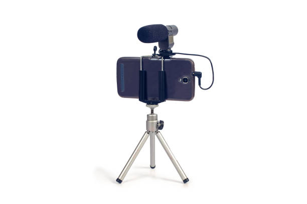 istock streaming video live with smart phone and microphone tool. 1153814741