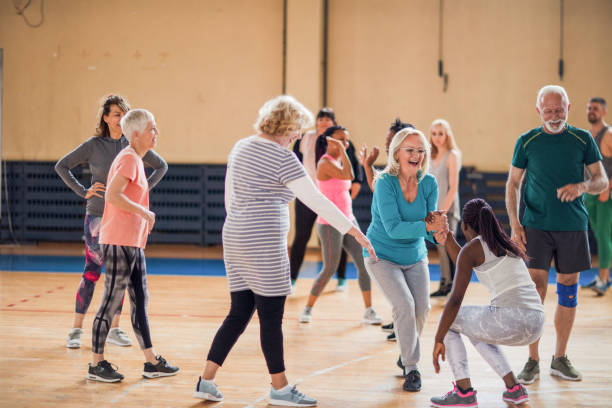 istock Senior lady supporting younger woman on their Zumba class 1153818608