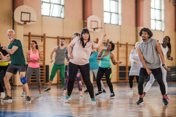 istock Large group of people dancing at Zumba class 1153818640