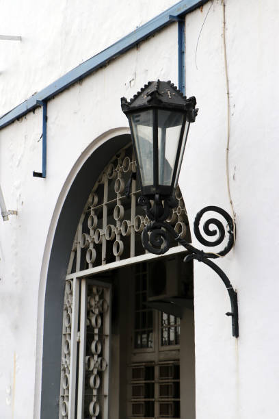 istock Metal lantern and glass installed beside arched door. 1153819840