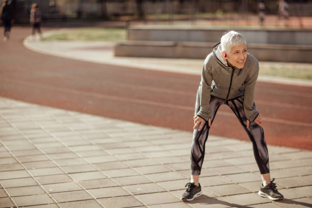 istock Senior woman resting after jogging 1153819938