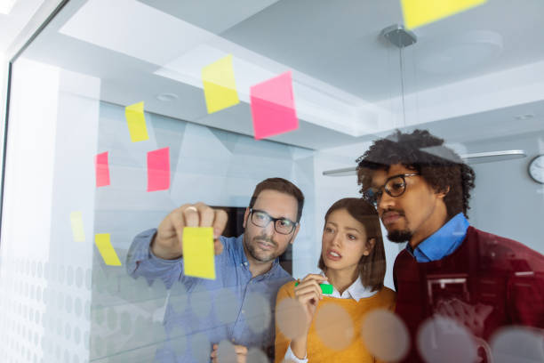 istock Business people brainstorming ideas behind glass wall 1153820000