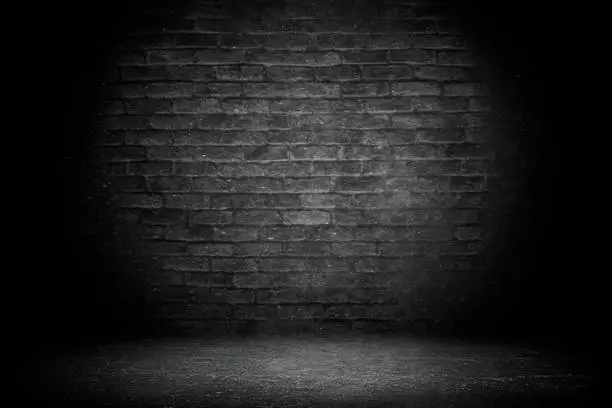 Photo of Abstract black brick with vignette background. Studio backdrop - well use as back drop background, black board, black studio background, black gradient frame
