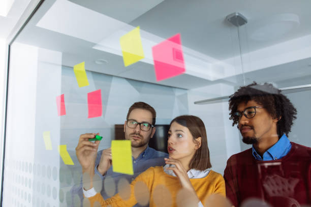 istock Business people brainstorming ideas behind glass wall 1153822455