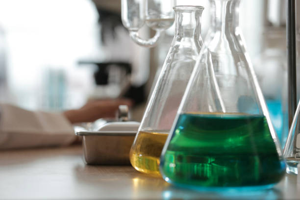 istock green and yellow solutions in beaker 1153822458