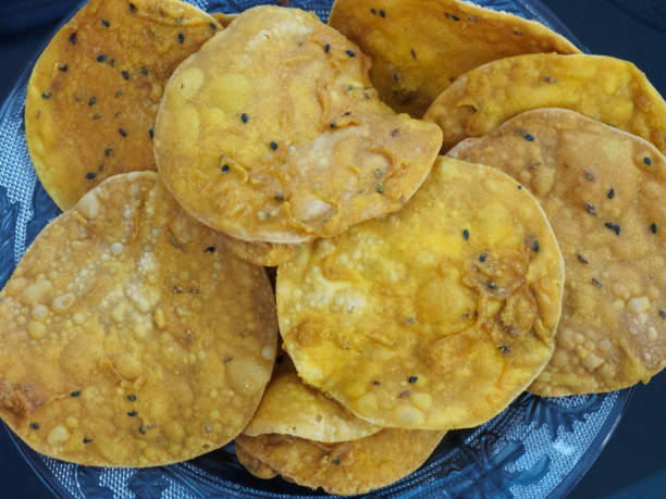 istock Indian yellow bread on a blue transparent plate 1153822679