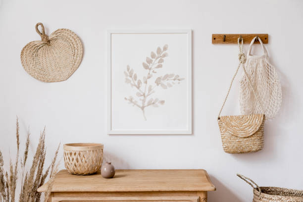 stylish korean interior of living room with brown mock up poster frame, elegant accessories, flowers in vase, wooden shelf and hanging rattan leaf, bags. minimalistic concept of home decor. template. - armchair sofa leather brown imagens e fotografias de stock