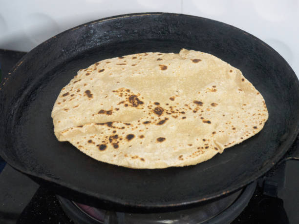 istock Cooking Indian Chapati bread in Kochi, Kerala 1153824042