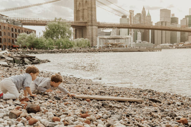 istock Boys playing in the Brooklyn Bridge Park, New York 1153824676
