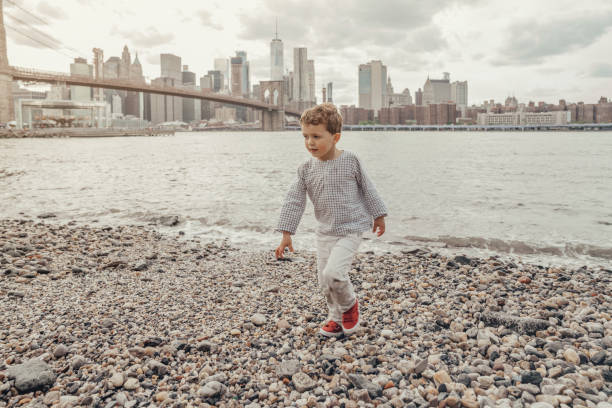 istock Boy playing in the Brooklyn Bridge Park, New York 1153824700