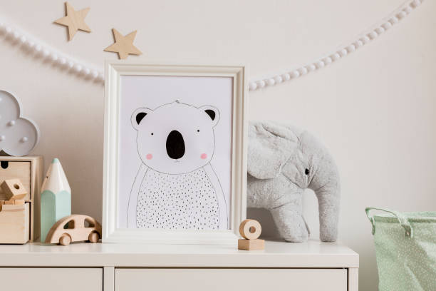 Stylish scandinavian newborn baby shelf with mock up photo frame, cotton basket, plush elephant, big mint crayon, wooden box and car. White garland and wooden stars on the wall. Home decor. Stylish and modern scandinavian newborn baby interior with mock up photo or poster frame. Wooden toys and accessories. nursery bedroom photos stock pictures, royalty-free photos & images