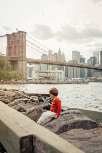 istock Boy playing in the Brooklyn Bridge Park, New York 1153825419