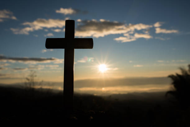 istock Silhouette of catholic cross and sunrise 1153828288