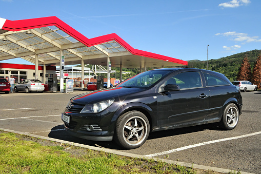 Usti nad Labem, Czech republic - May 30, 2019: black car Opel Astra stand on filling station of Benzina company