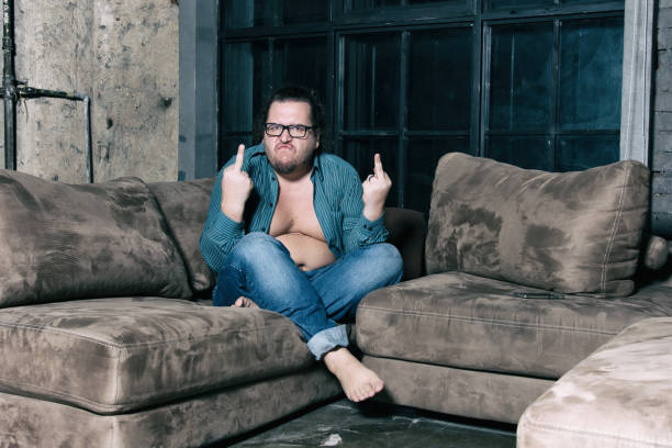istock Funny fat man resting at home 1153828379