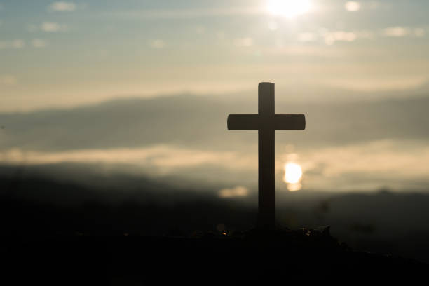istock Silhouette of catholic cross and sunrise 1153828515