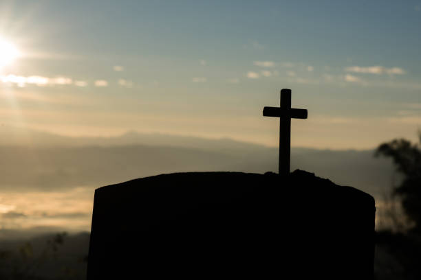 istock Silhouette of catholic cross and sunrise 1153828955