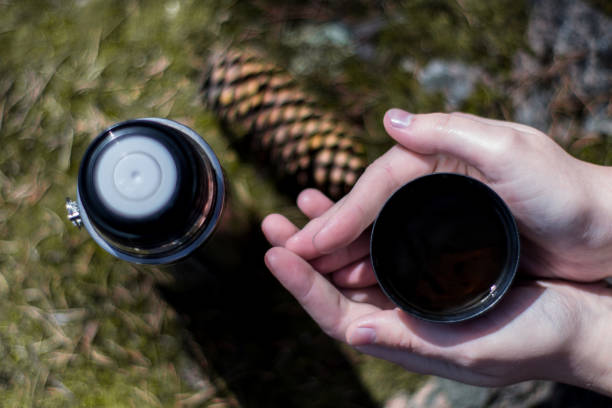 istock Two hands hold cup of hot tea or coffe 1153828962