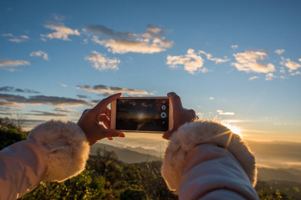 istock Hand holding a smartphone take a photo beautiful mountain 1153829171