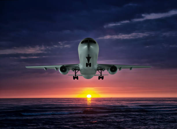 istock The night flight. Airplane over the sea 1153829979