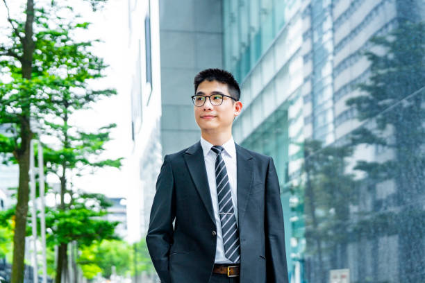 istock Thoughtful businessman looking away in city 1153833090