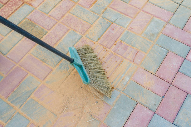 istock Broom swipes paved walkway grouted with sand 1153834341