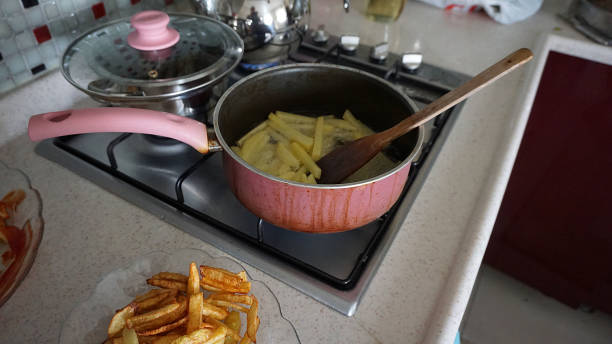 istock in the kitchen to make potato fries, fried potatoes for breakfast, 1153835085