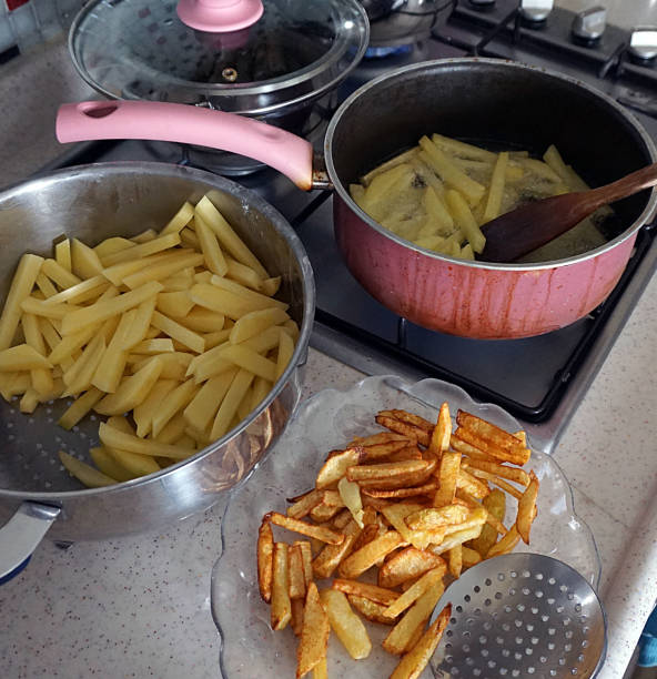 istock in the kitchen to make potato fries, fried potatoes for breakfast, 1153835233