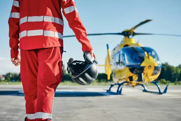 Alarm for helicopter emergency medical service. Paramedic running to helicopter on heliport. Themes rescue, help and hope.
